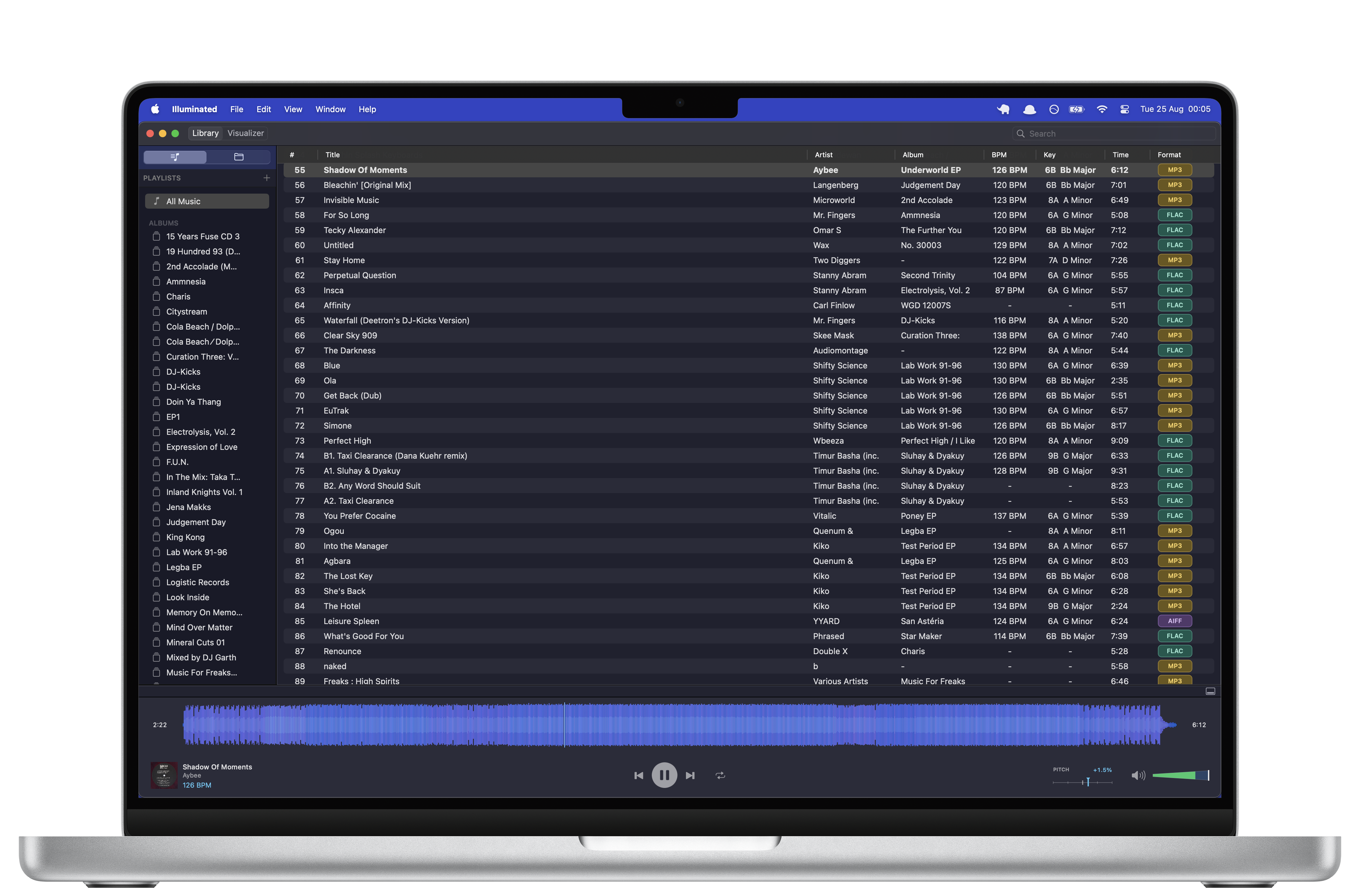 Illuminated on MacBook showing a local music library with BPM, musical key, format, metadata, and a full-track waveform