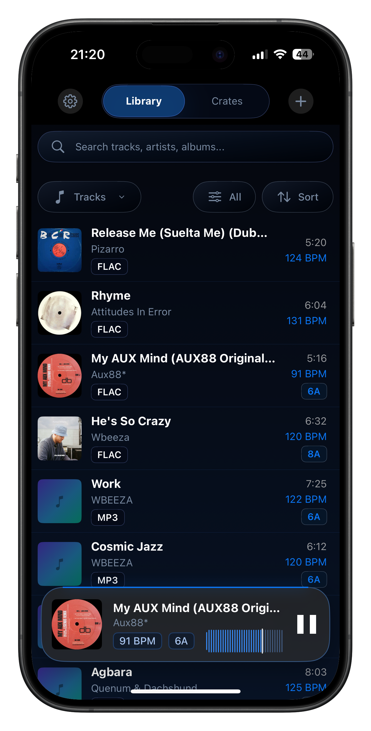 Illuminated on iPhone showing a local music library with BPM, key, format, and compact playback controls